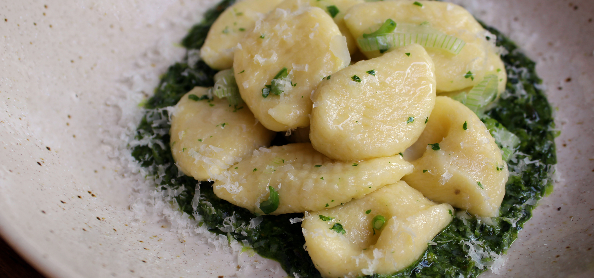 Potato Gnocchi with Kale and Pistachio Pesto and Spring Onions