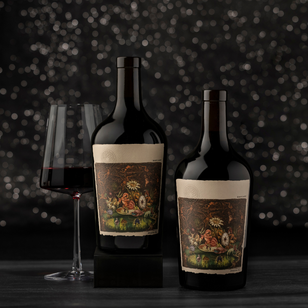 Two dark wine bottles with illustrated labels, showcasing Washington's Finest Wine, stand beside a filled glass of red wine, set against a dark, sparkling background on a dark tabletop—a perfect wine gift for any occasion.